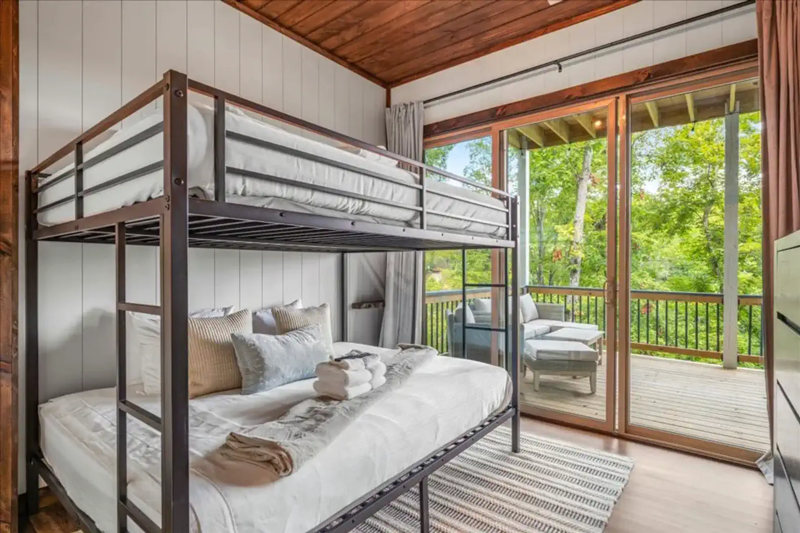Queen over queen bunk bed with access to the deck so guest in each room can enjoy the views. 