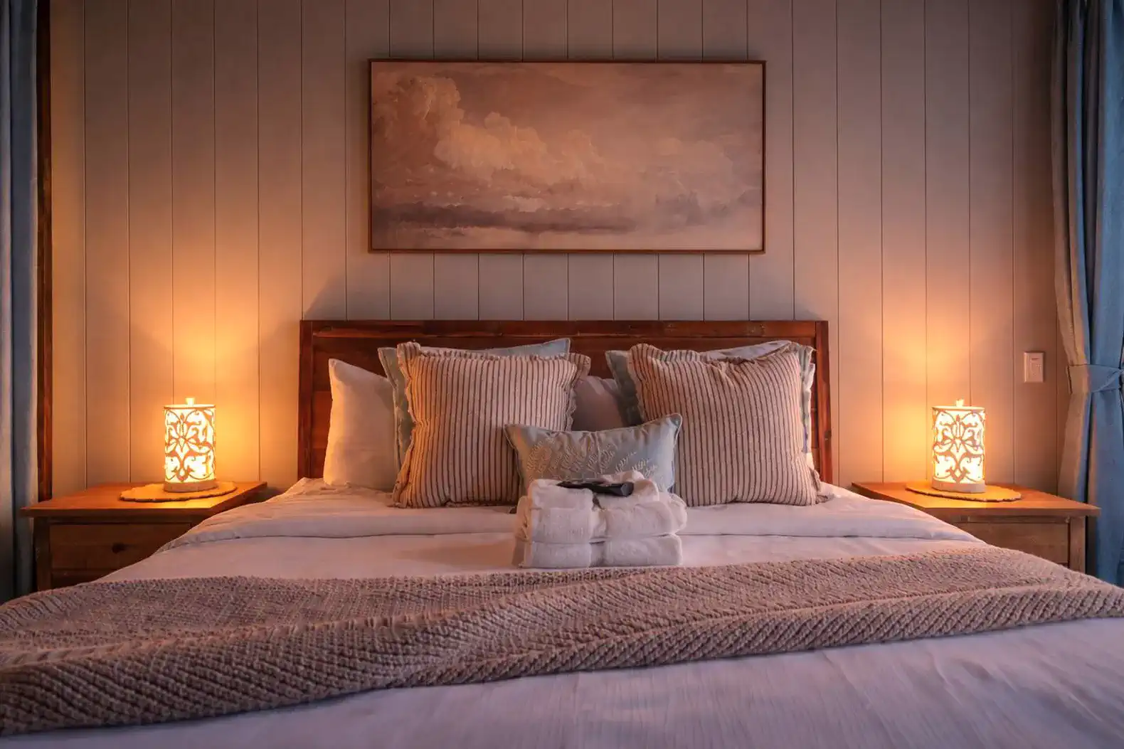 Primary king bedroom located on the main level with plenty of pillows and blankets to keep you cozy. 