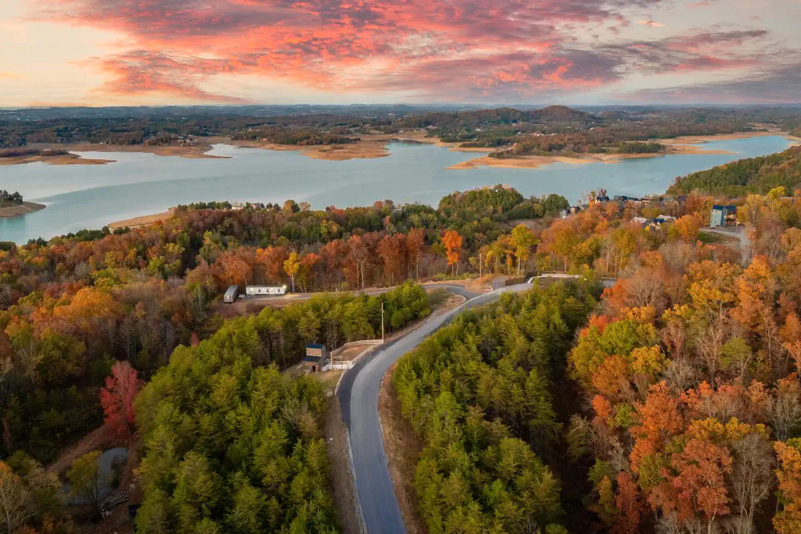 Scenic view of Lake Douglas surrounded by autumn foliage and winding road