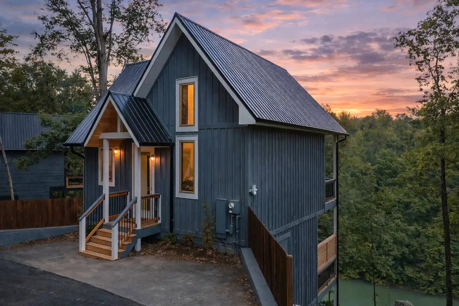 Front of cabin view with beautiful sunset and lake view behind the property