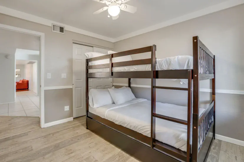 Cozy bunk room featuring a wooden bunk bed with a double bed on the bottom and twin on top