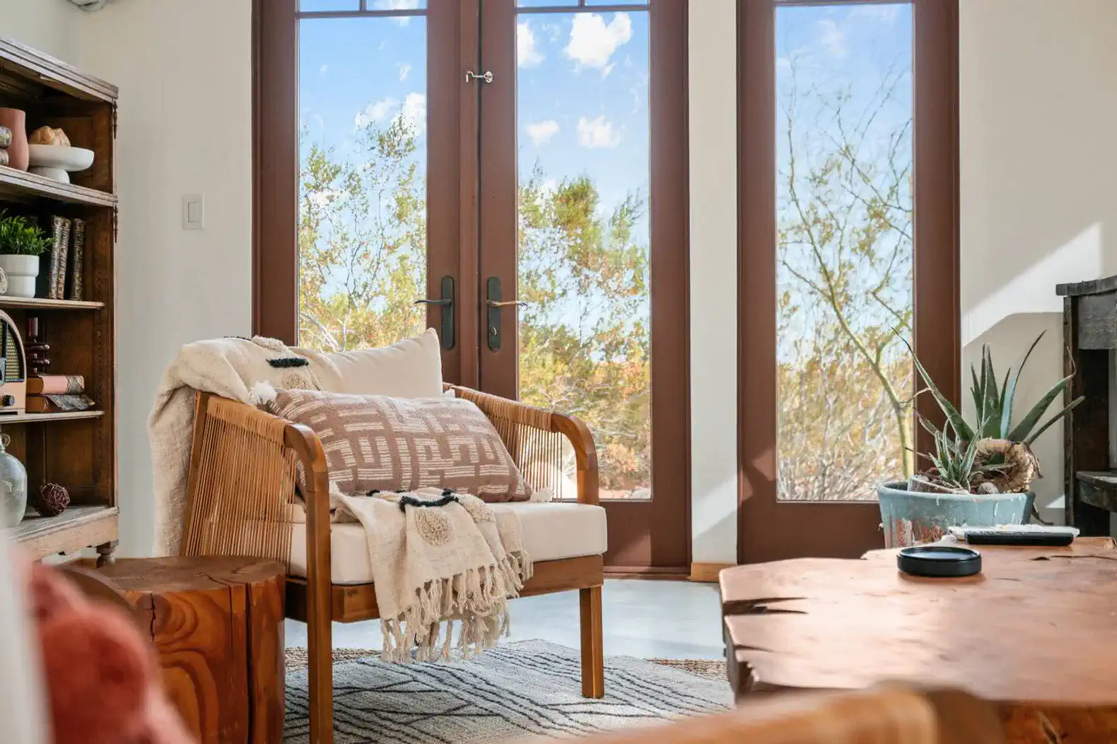 Cozy seating area with large windows showcasing a natural view