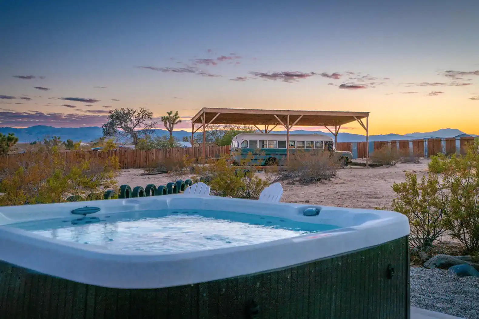 Hot tub with desert landscape and sunset view in the background
