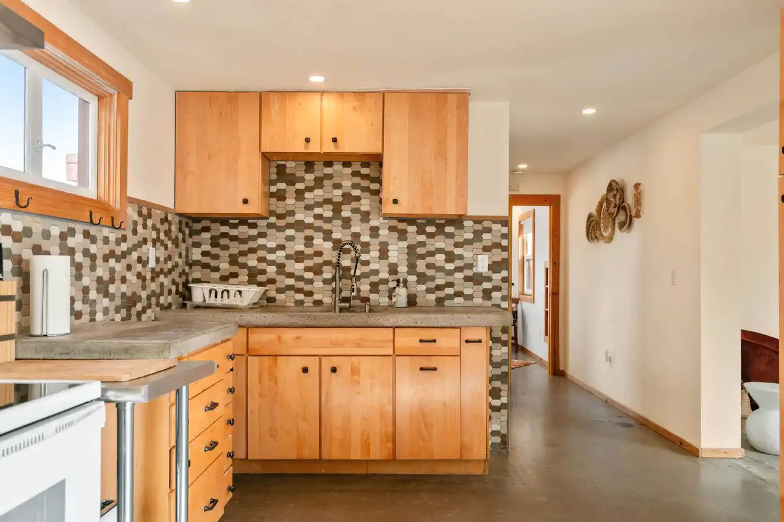 Modern kitchen with wooden cabinets and patterned tile backsplash