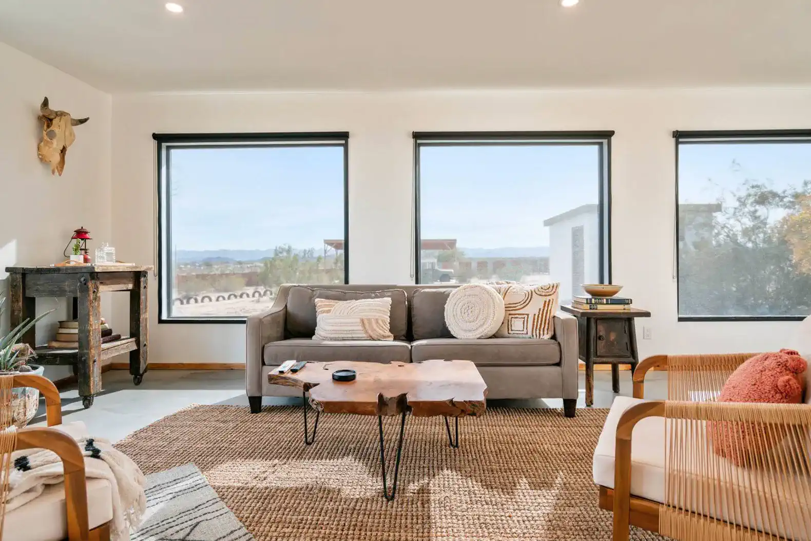 Cozy living room with large windows offering scenic views and modern furnishings