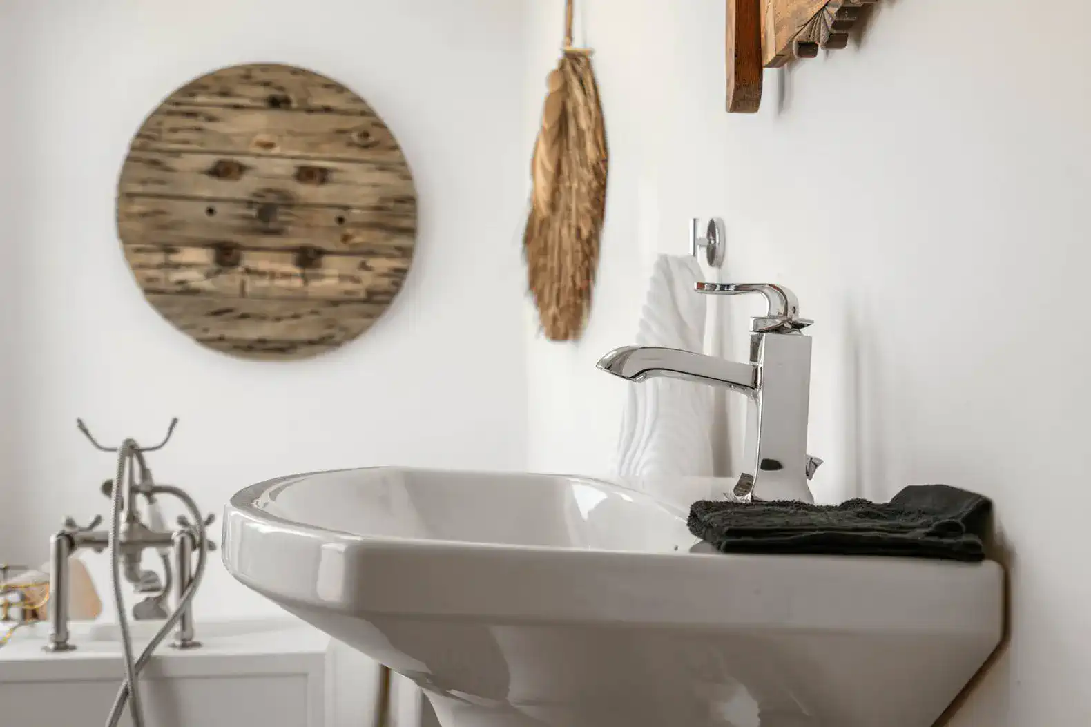 Stylish bathroom sink with modern faucet and decorative wall art