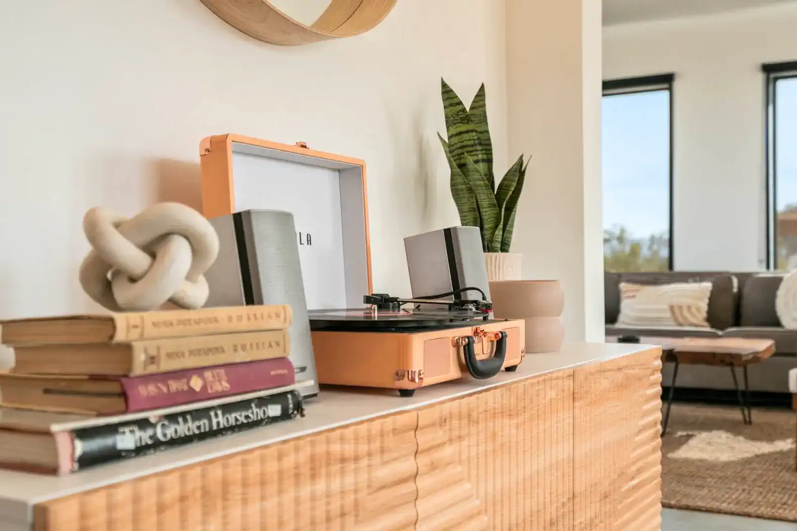 Stylish living room decor featuring a record player, books, and a cozy seating area