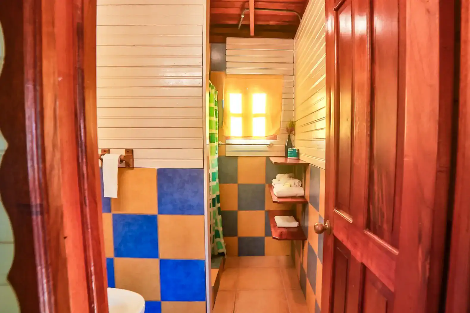 Brightly colored bathroom with tiled walls and natural light