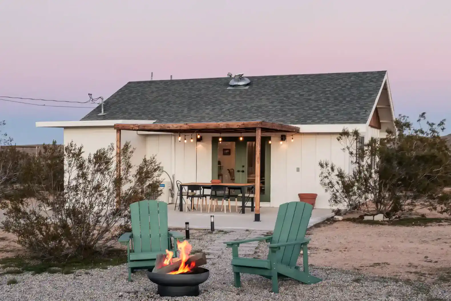 Cozy outdoor seating area with fire pit and desert landscape