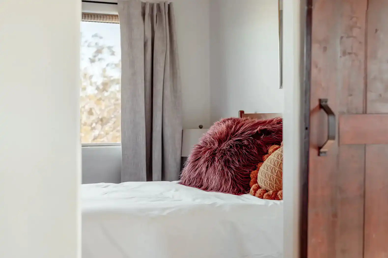 Cozy guest bedroom with plush pillows and natural light