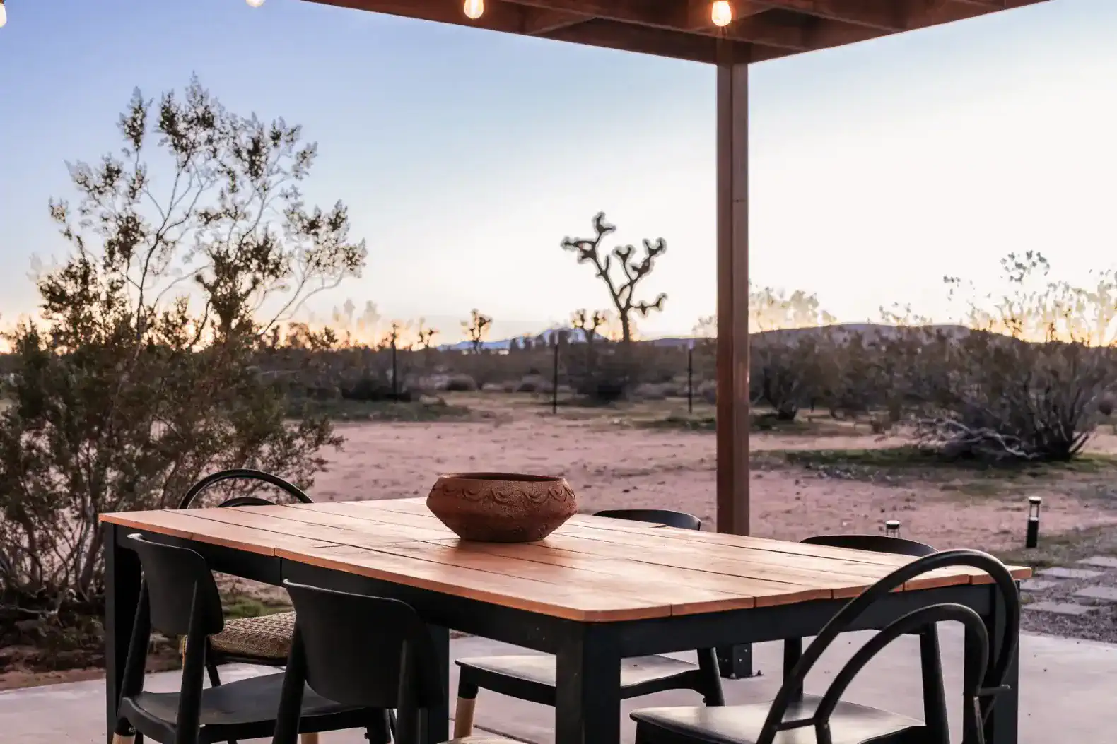 Outdoor dining table with a desert view at sunset
