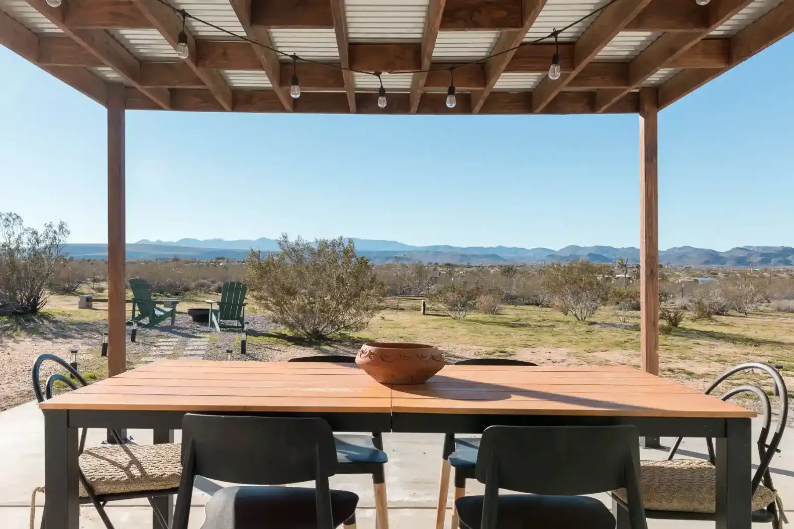 Outdoor dining area with a view of the desert landscape and mountains