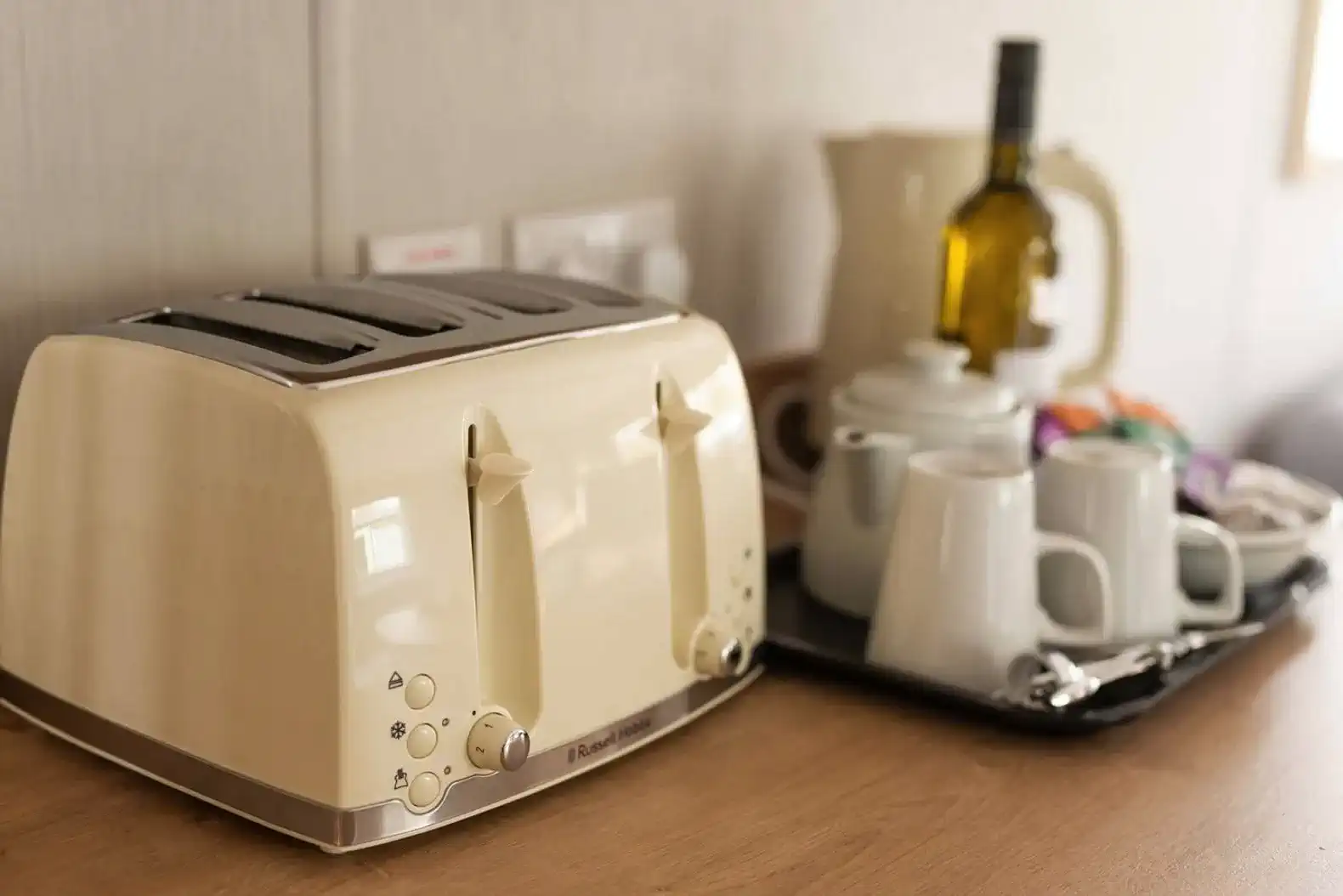 Toaster and tea set on a wooden countertop