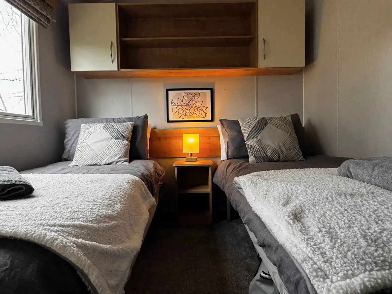 Cozy guest bedroom with two twin beds and warm lighting