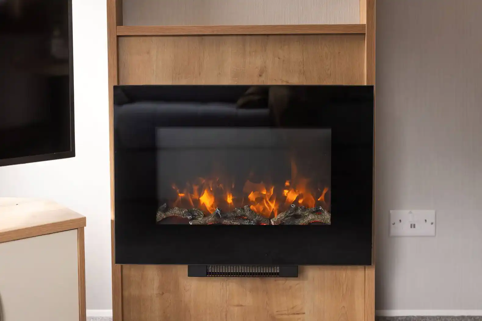 Enjoy the electric fireplace, providing instant ambiance and comfort after a long day exploring the Lake District