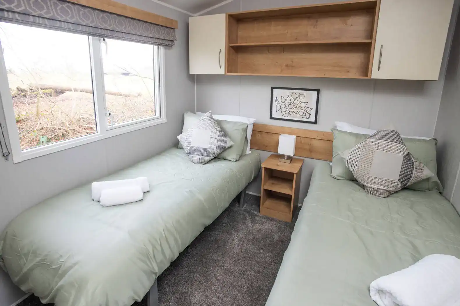 Relax in two single beds featuring premium linens for a hotel-quality sleep. This room is "long-stay ready," equipped with a full wardrobe and drawers to keep your belongings organised and your stay clutter-free