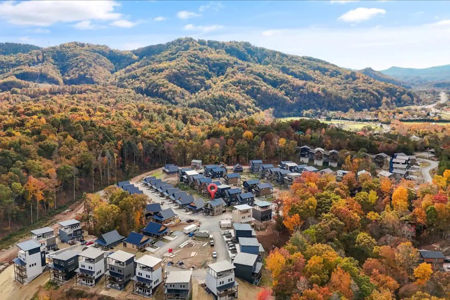 Aerial view of a mountain community surrounded by colorful autumn foliage