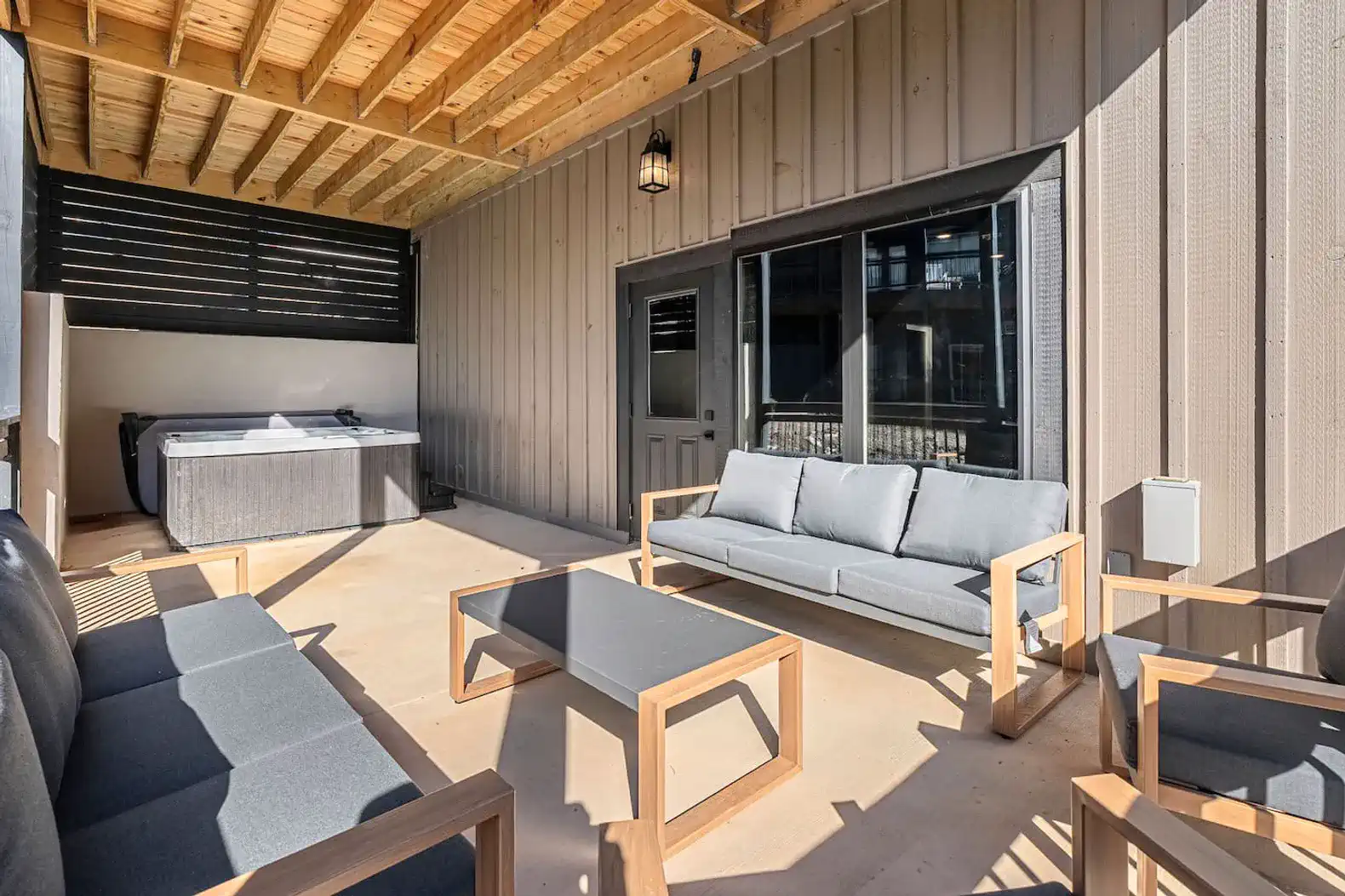 Lounge seating and private hot tub located on the lowest level patio so you can relax in peace. 