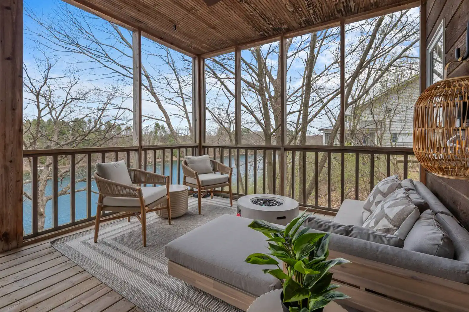 The main level veranda features soft, inviting seating perfect for soaking in the stunning views. Light up the gas-powered fireplace table to create a warm and cozy ambiance. 