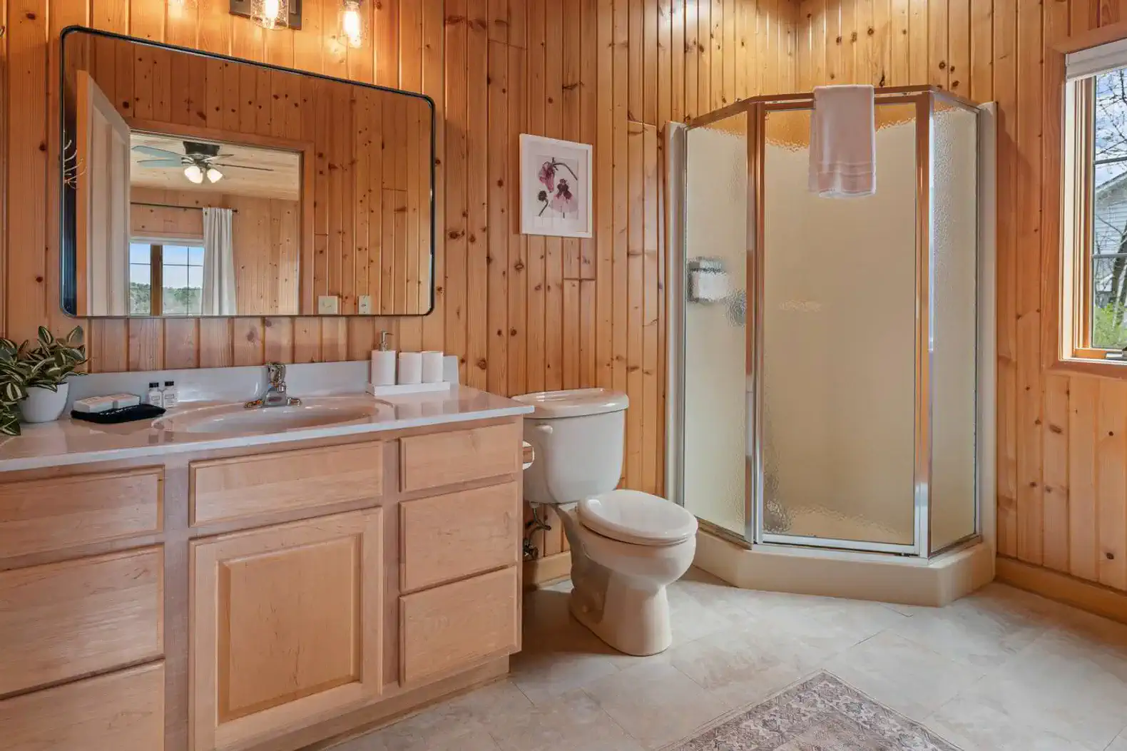 En suite full bathroom with an authentic cabin feel, stocked with fresh linens and essential toiletries.