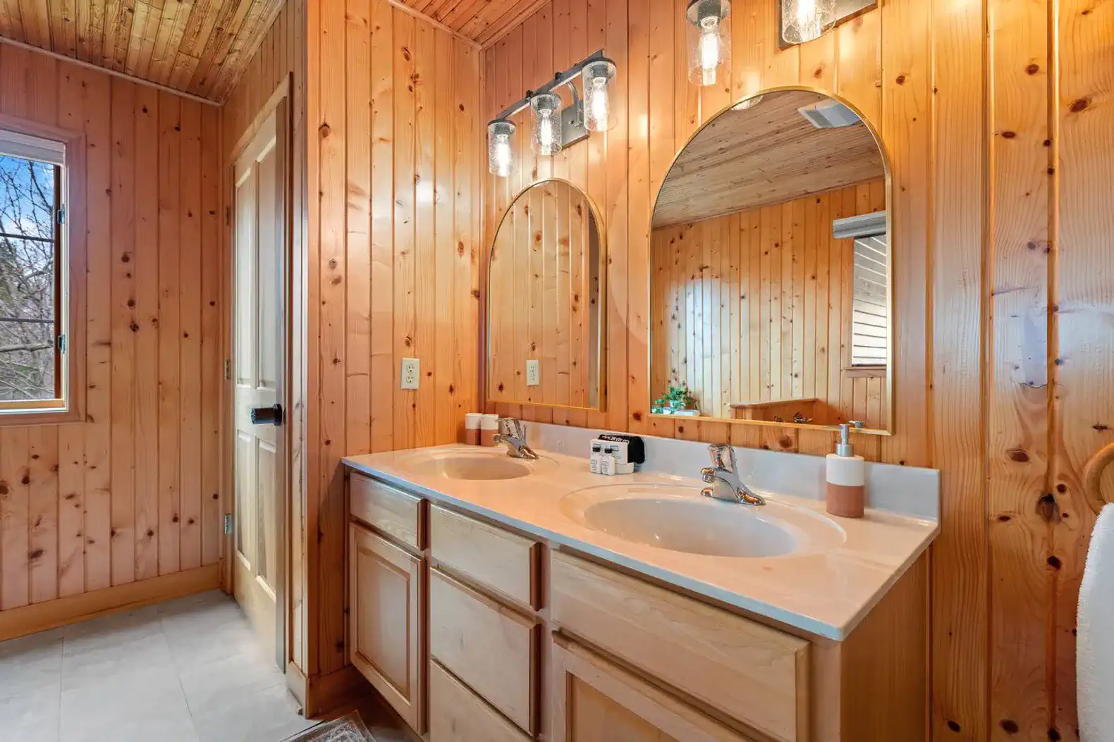 Second-floor authentic cabin bathroom featuring a large tub, separate shower, fresh linens, and essential toiletries.