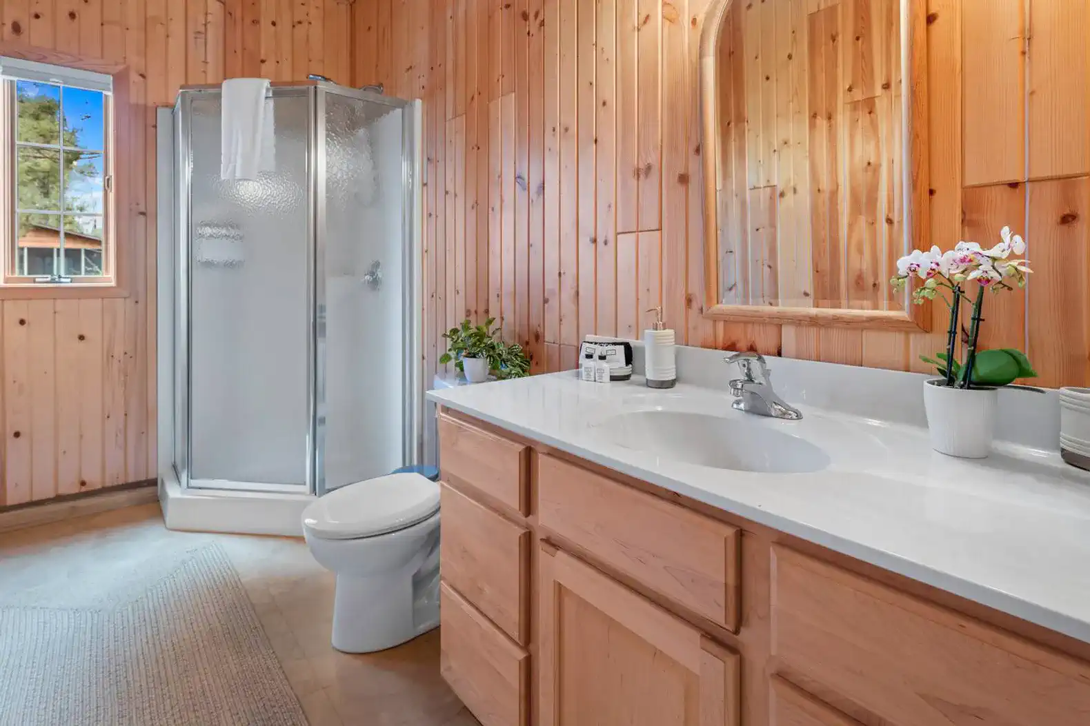 Classic cabin bathroom on the first floor with a shower, plenty of fresh linens, and essential toiletries for your stay.
