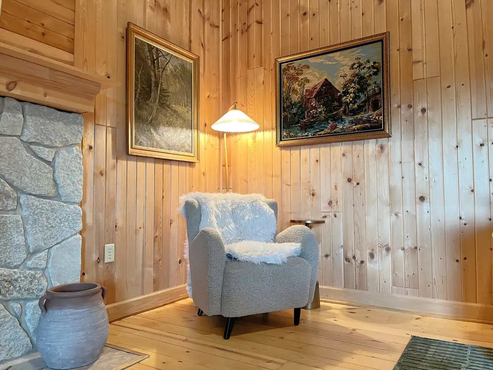 Cozy reading nook with a plush chair and wooden walls