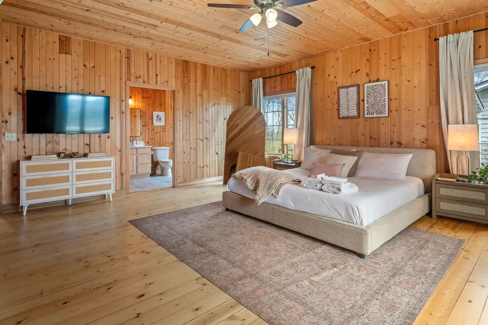 Spacious bedroom with a king bed, Smart TV, and a double-sized reach-in closet with hangers. Enjoy the convenience of a private en suite full bathroom.