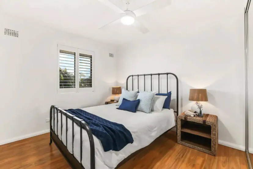 Comfortable queen bed with large wardrobe.