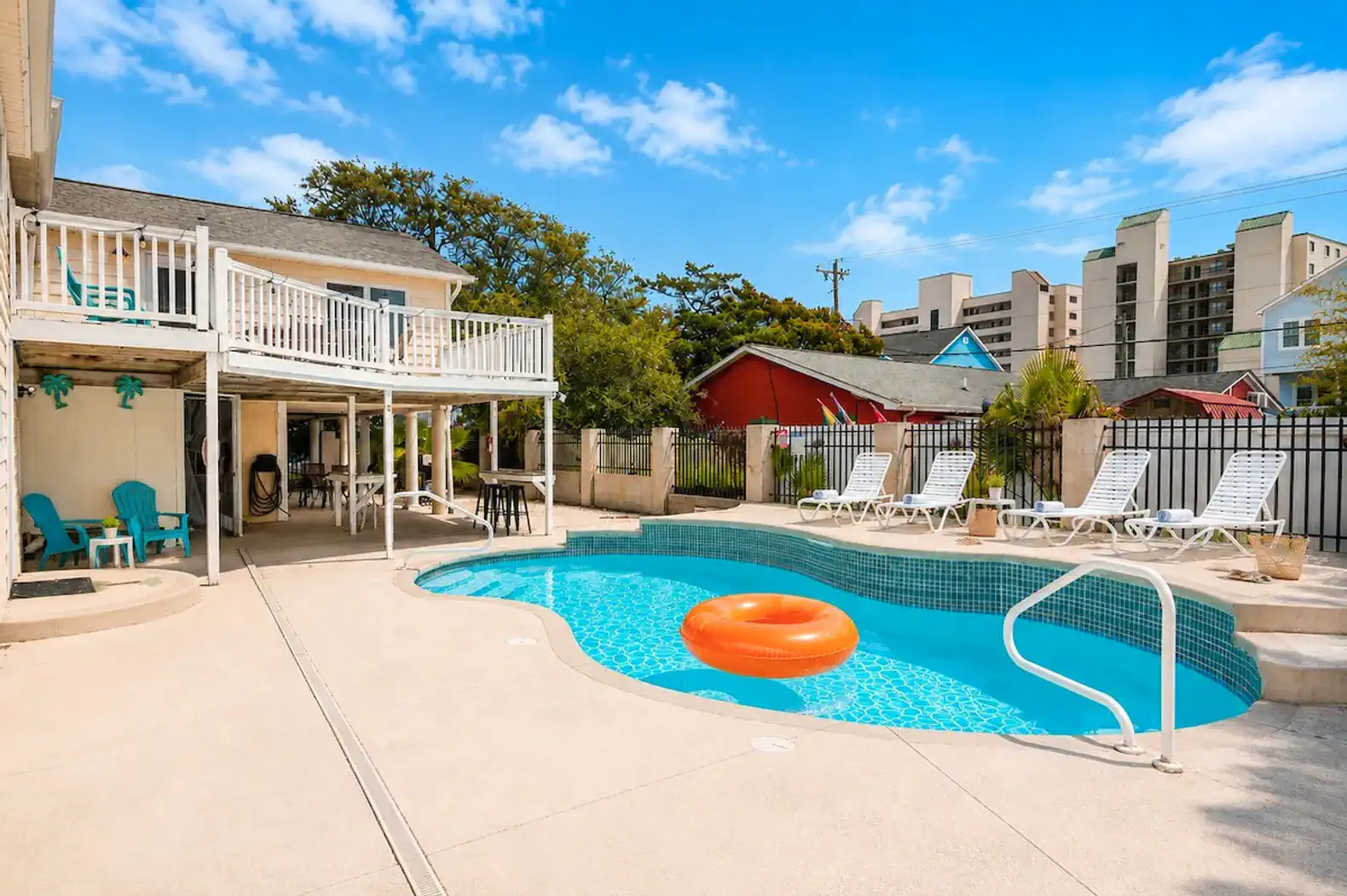 Inviting pool area with lounge chairs and an orange float