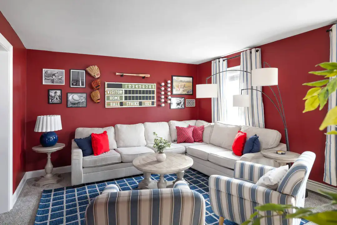 Cozy living room with red walls, sectional sofa, and decorative accents