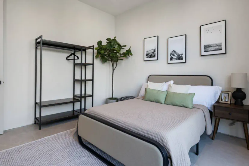 Cozy guest bedroom with a bed, decorative pillows, and minimalist decor