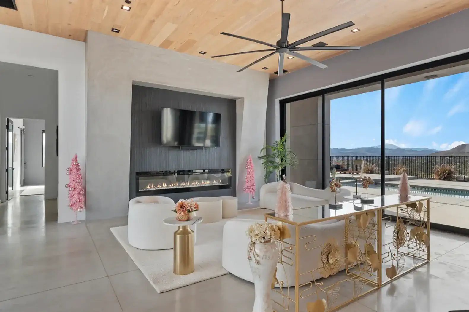 Spacious living room with modern decor, large windows, and mountain views