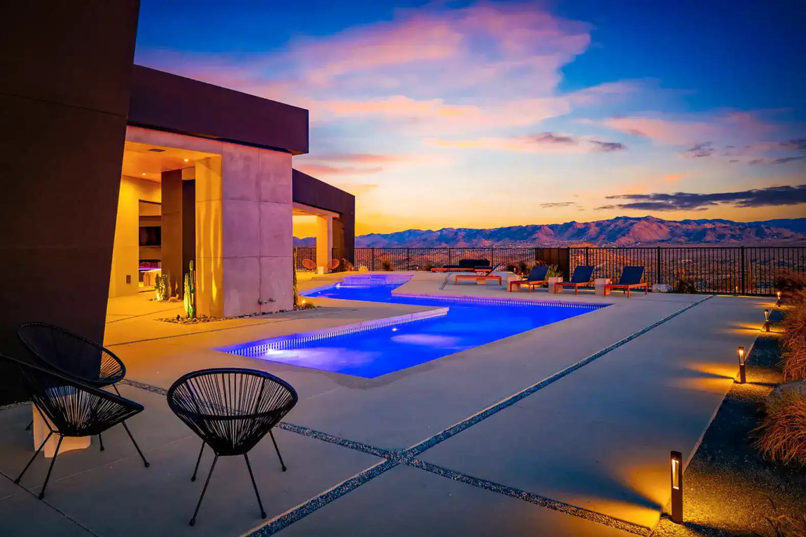 Outdoor area featuring a pool with mountain views at sunset