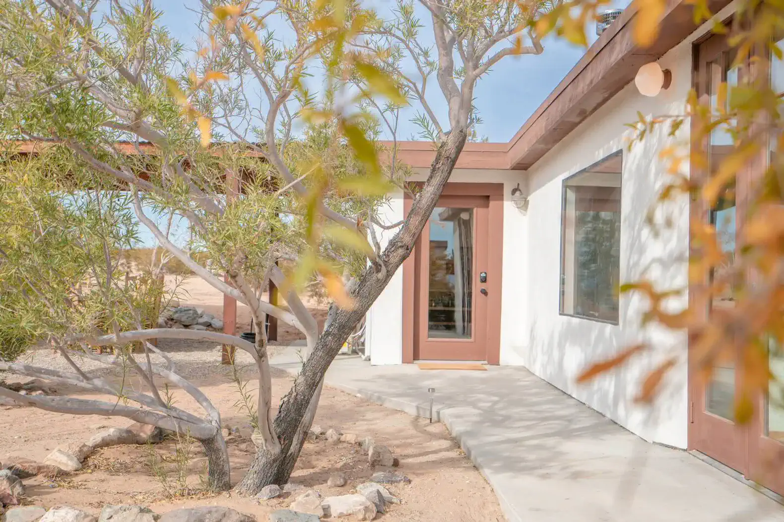 Welcoming entrance with a landscaped path and desert plants