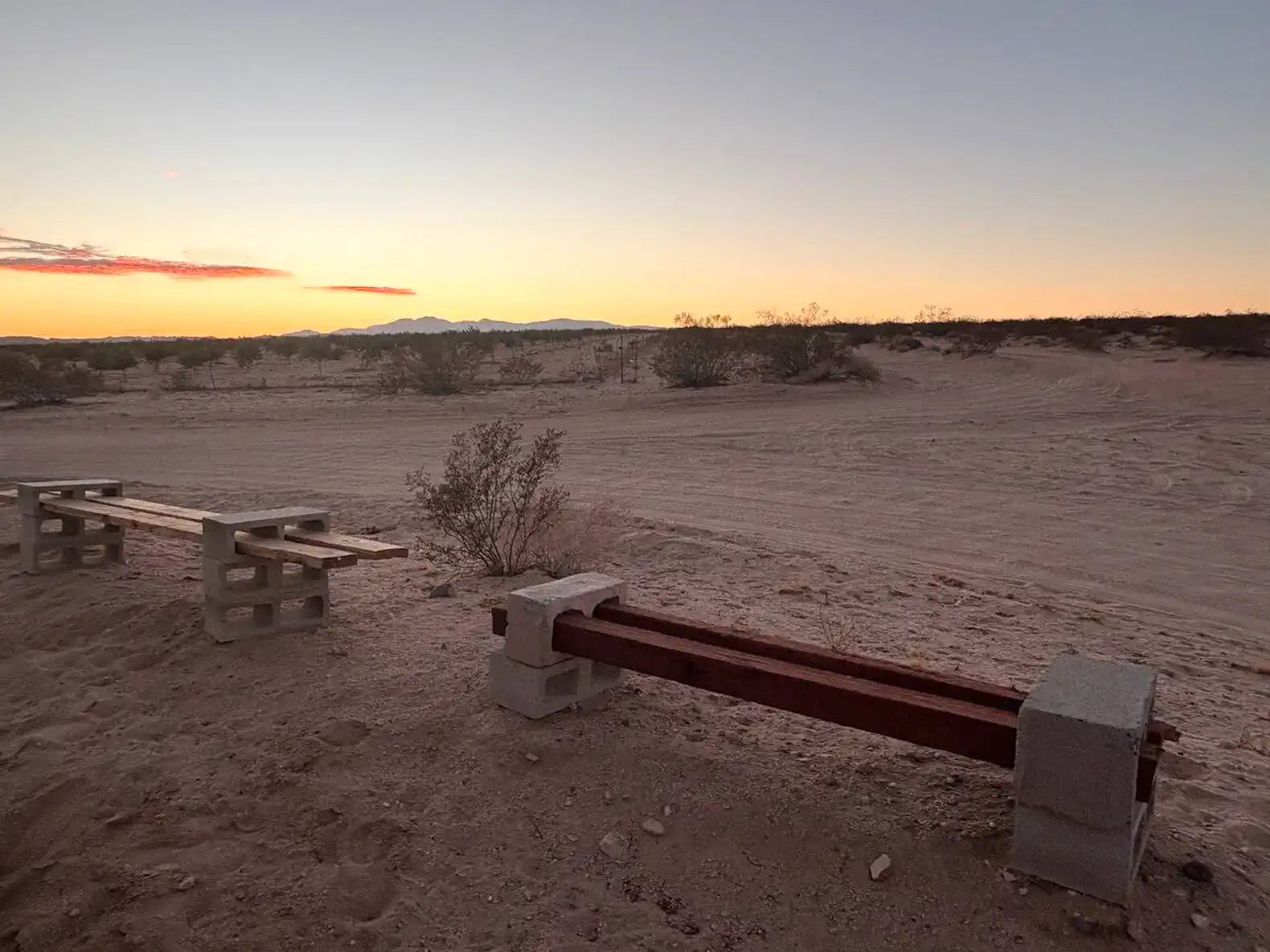 Desert landscape with benches and a sunset view