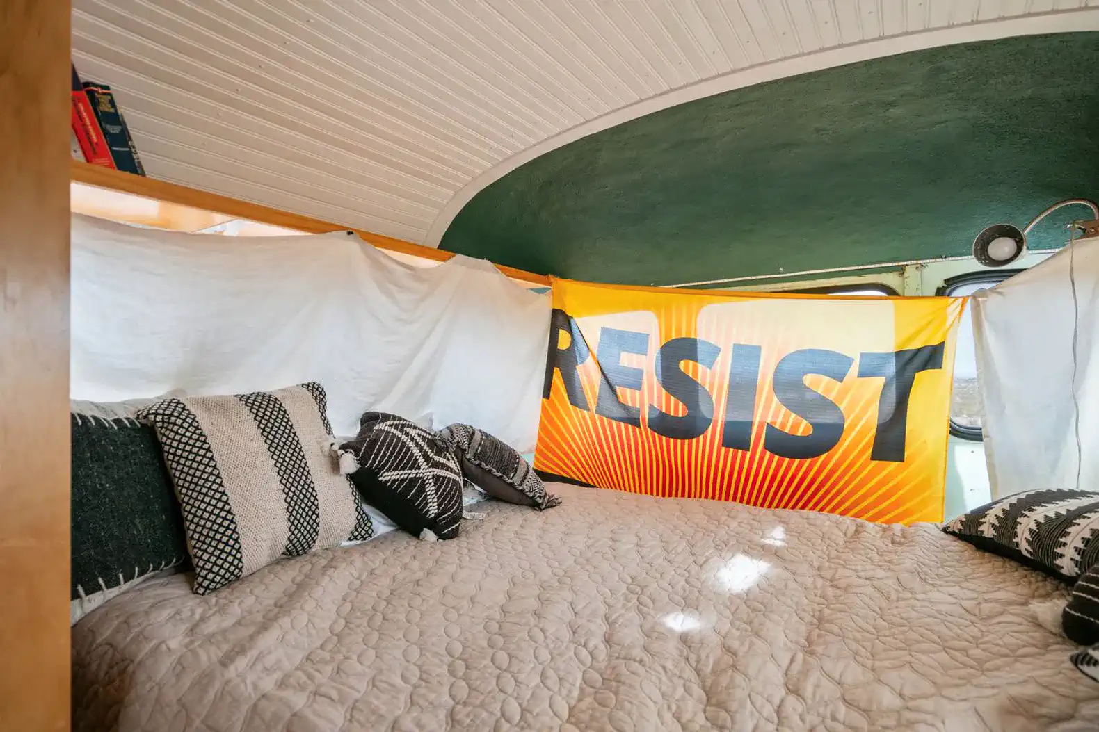 Cozy bedroom with a colorful banner and decorative pillows