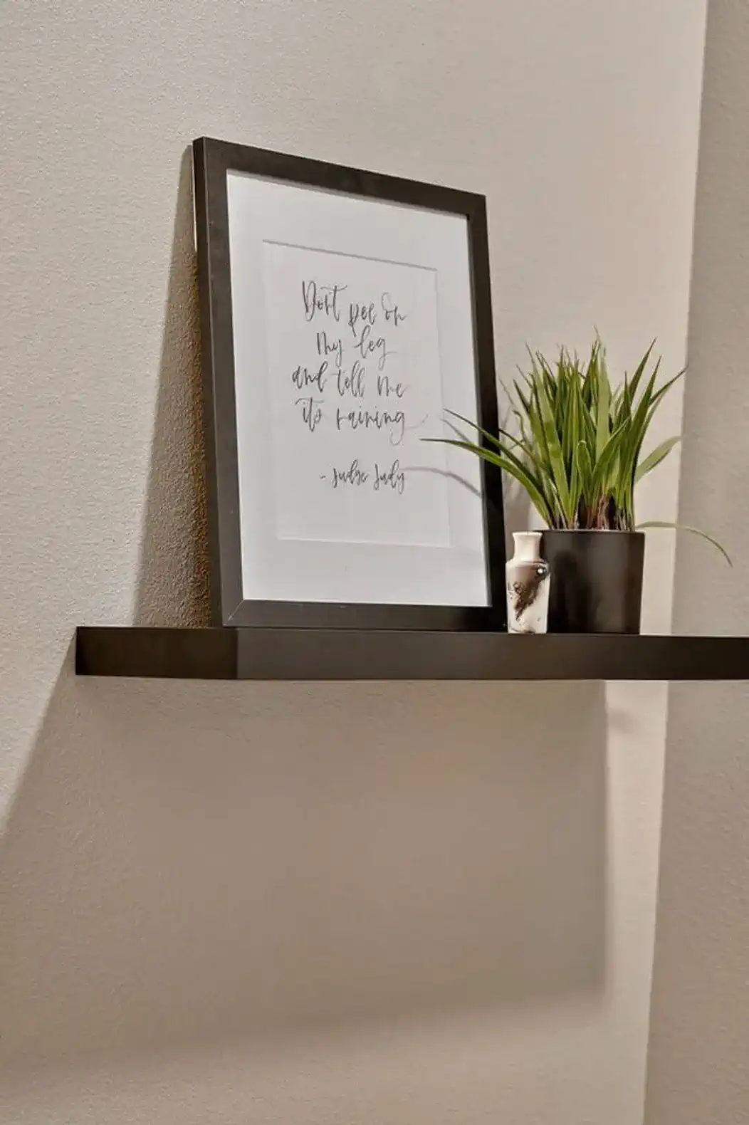 Minimalist artwork accents the bathroom space with color and design.