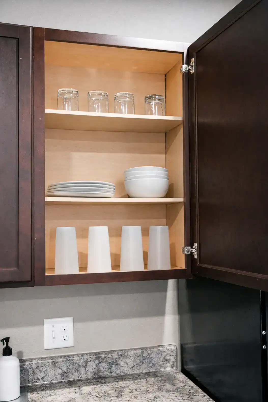 Cabinets are stocked with plates, bowls and glasses to comfortably serve everyone.