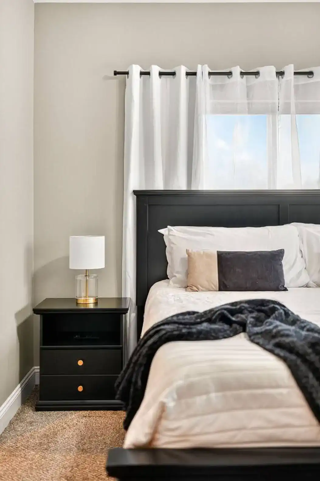 Layered bedding and throw blanket create a restful, inviting atmosphere.