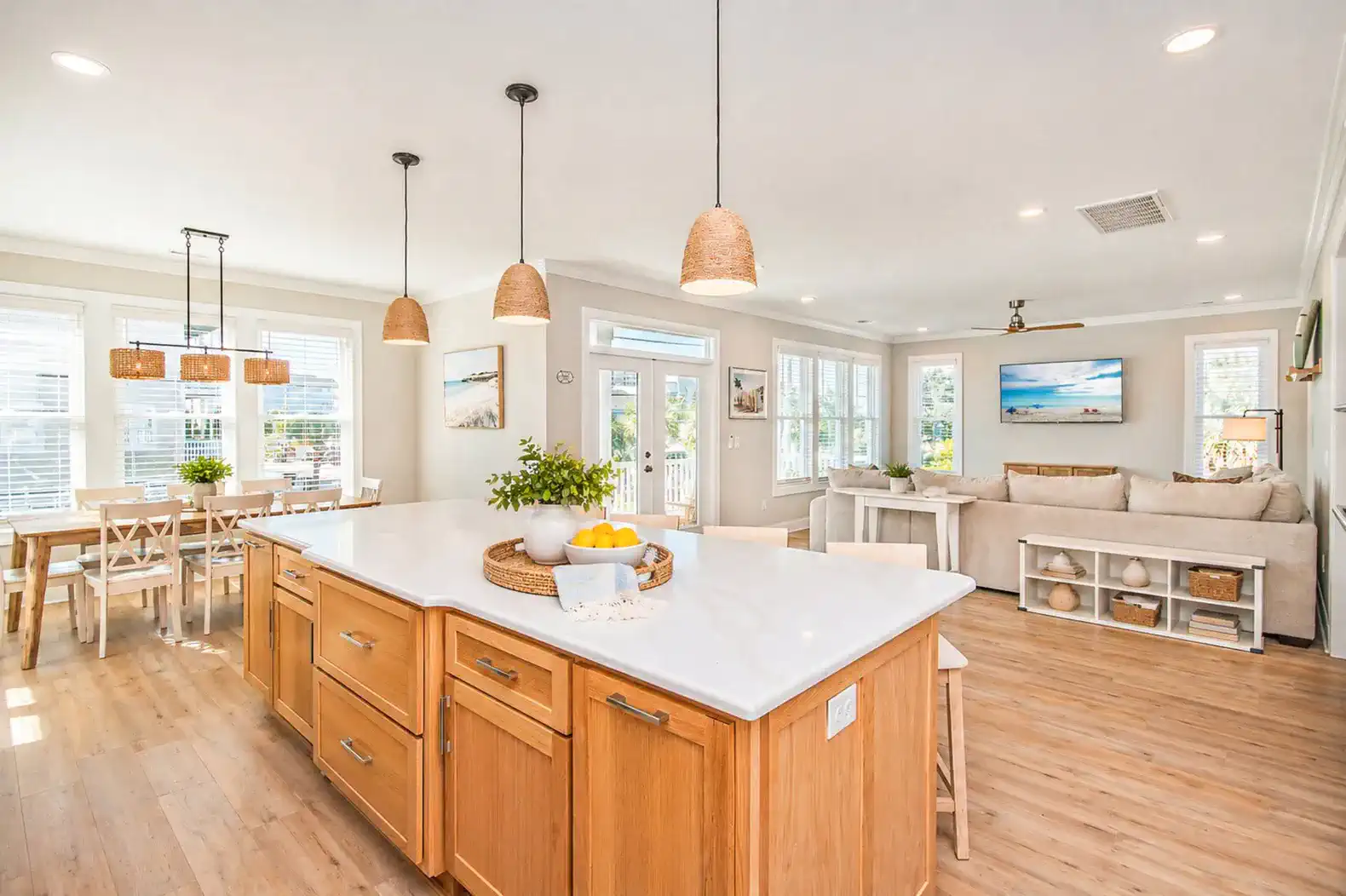 Bright kitchen with island, dining area, and living room in an open layout