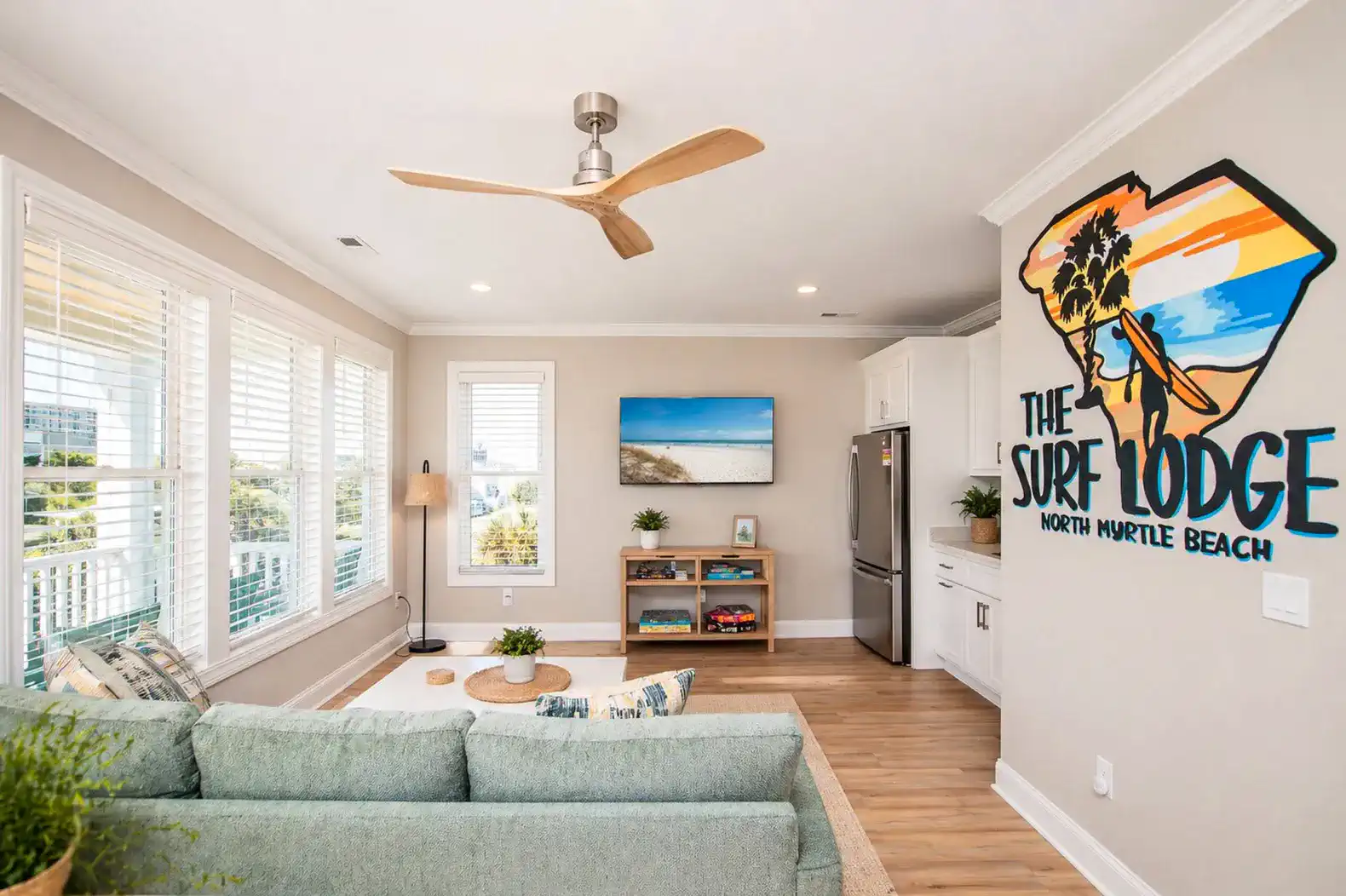 Cozy living room with beach-themed decor and large windows
