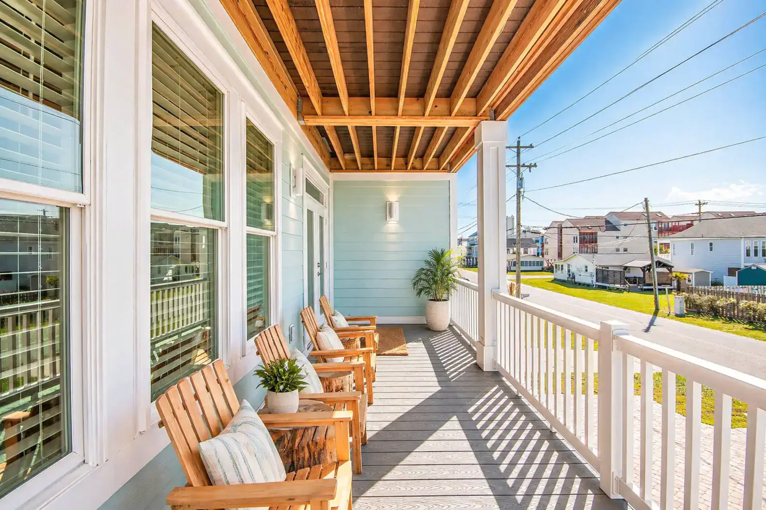 Spacious porch with wooden chairs and a view of the neighborhood