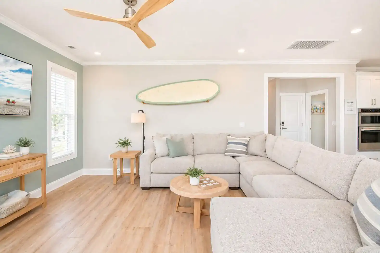Cozy living room with sectional sofa and beach-themed decor