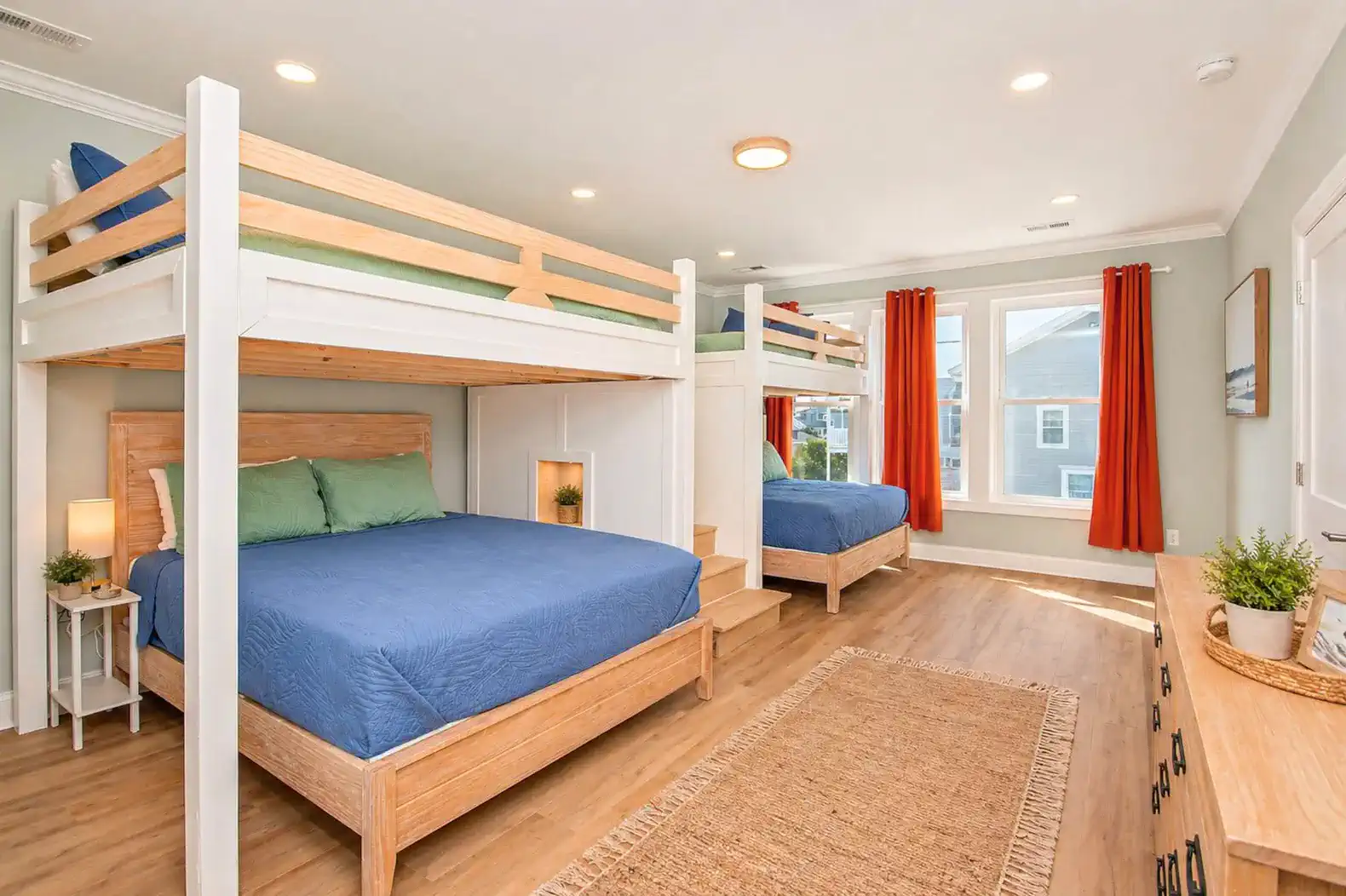 Bright and spacious bunk room with two sets of bunk beds and large windows