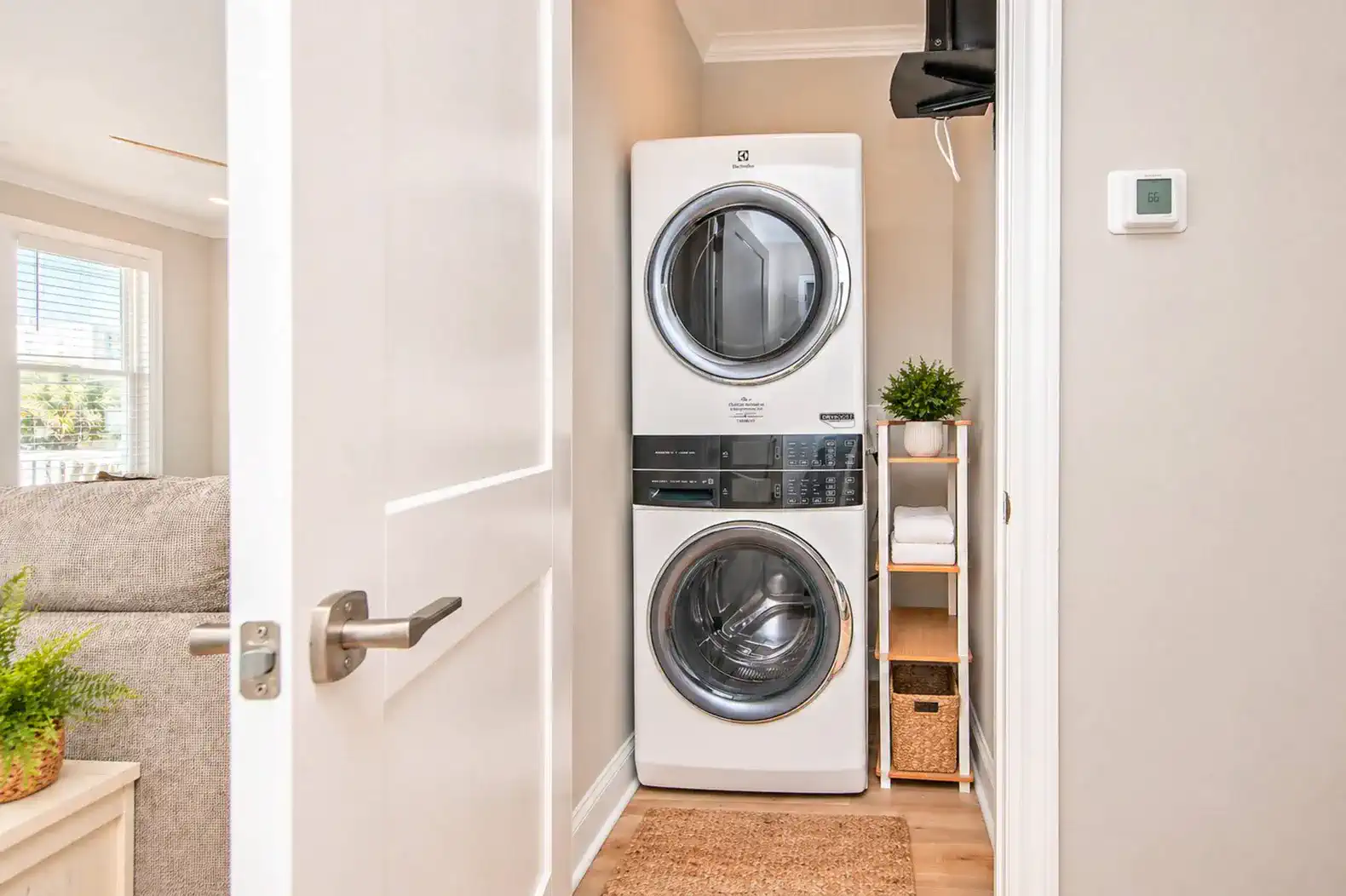 Stacked washer and dryer in a laundry nook with shelving