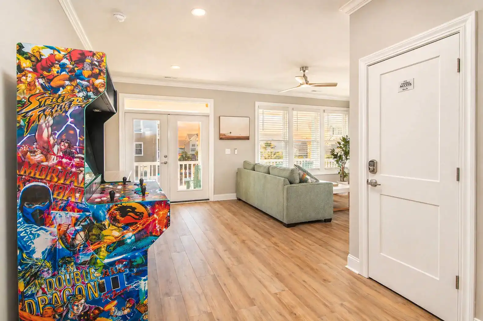 Colorful arcade game in a bright living area with a view of the patio