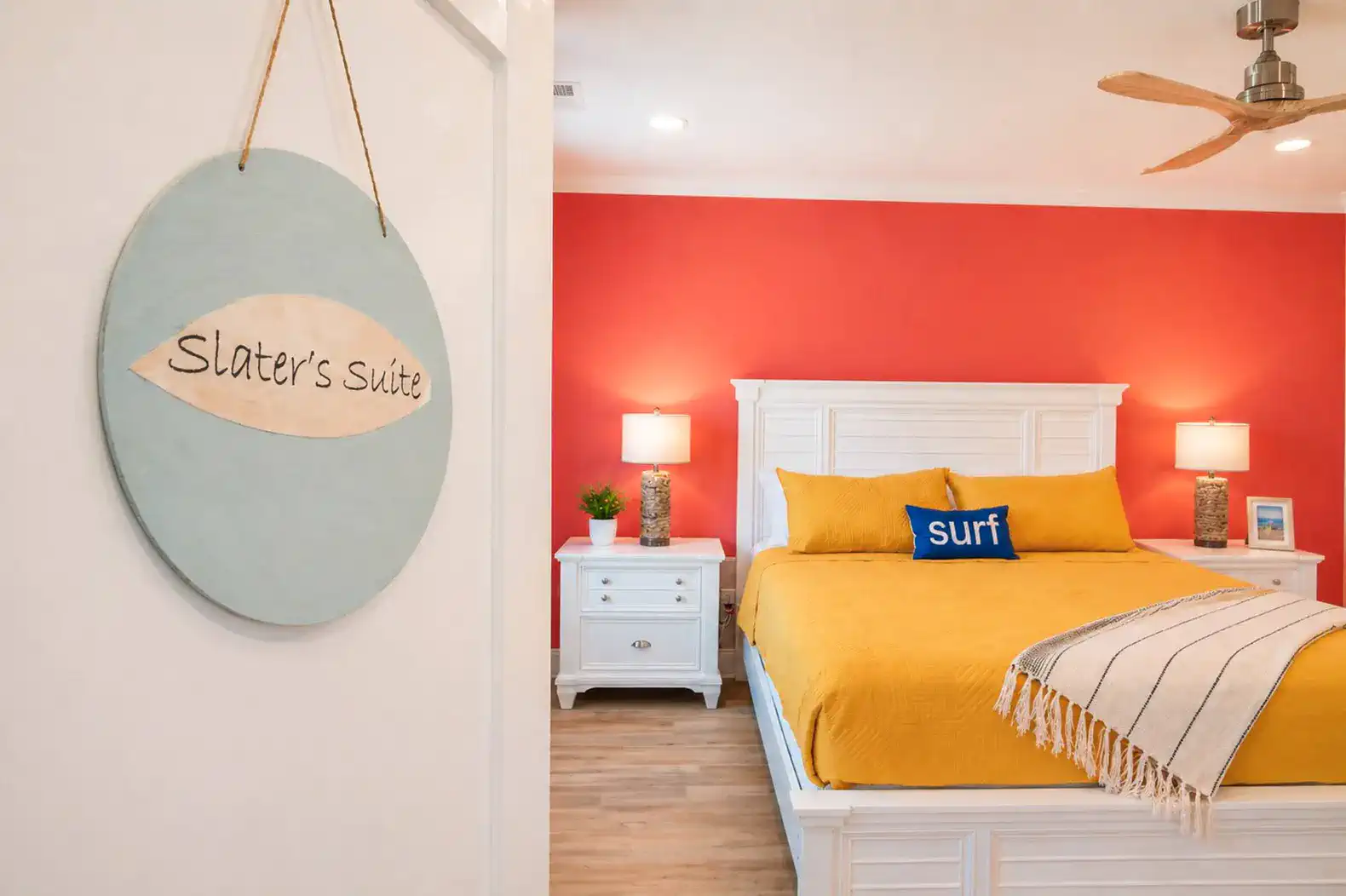 Brightly colored bedroom with a yellow bedspread and surf-themed decor