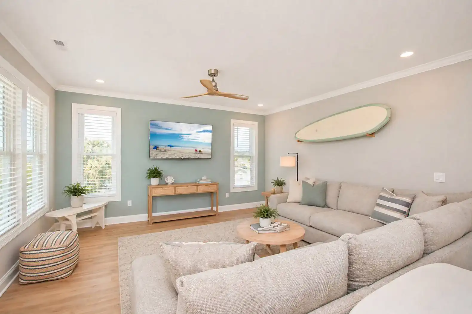 Cozy living room with large sectional sofa and beach-themed decor