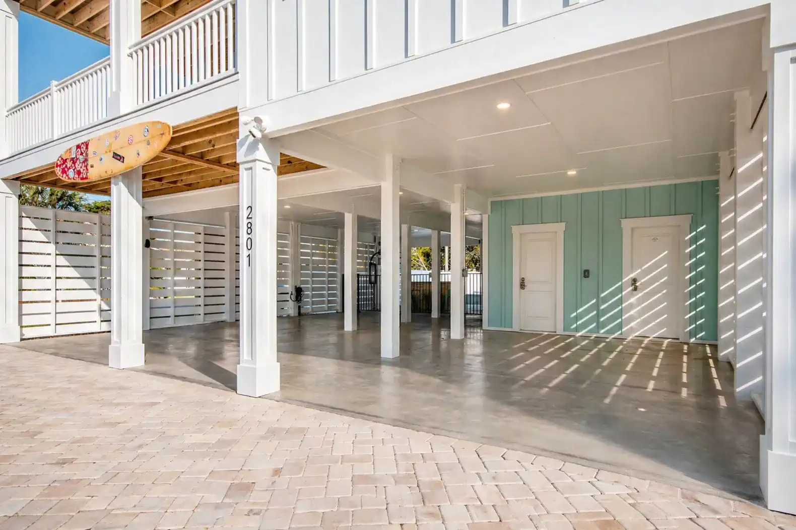 Spacious covered parking area with concrete flooring and light blue accent wall